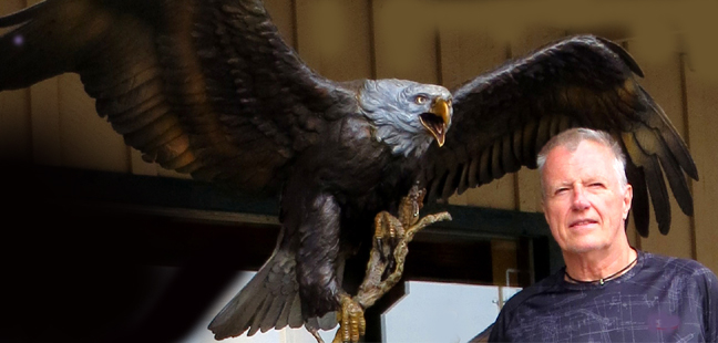 W. Hock Hochheim standing next to a statue of an eagle. Contact form adjacent to the picture.