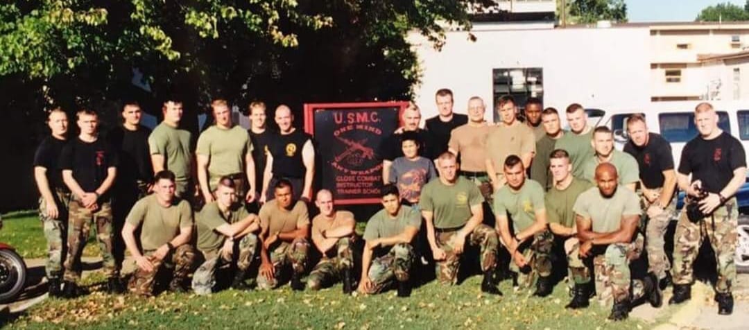 Hock in a group photo with U. S. Marines that he has trained.