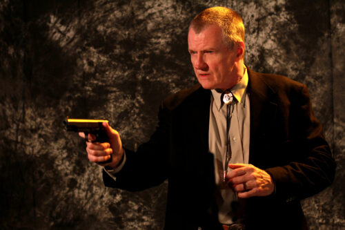 Survival Centric: Gun. Hock in a defensive pose with a hand gun.