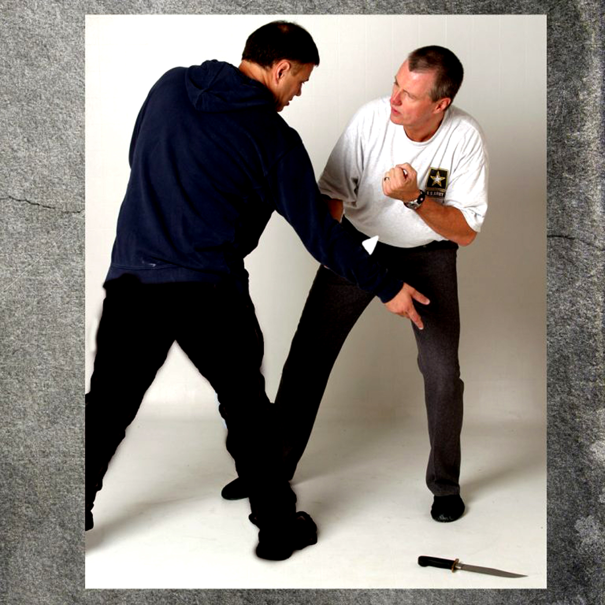 knife fight and man dropps the knife.