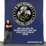 W. Hock Hochheim standing next to a seminar banner.