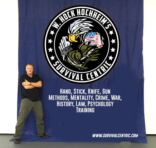 W. Hock Hochheim standing next to a seminar banner.